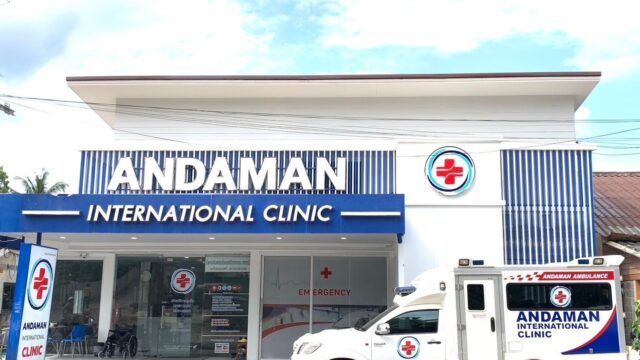 White clinic building with ANDAMAN INTERNATIONAL CLINIC sign and an ambulance parked in front.