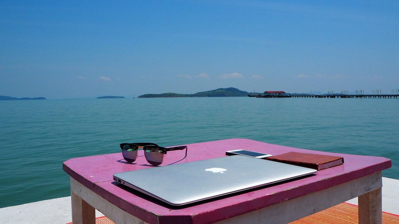 A laptop set up for remote work near the Koh Lanta coast